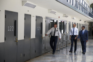 President Barack Obama is led on a tour by Bureau of Prisons Director Charles Samuels, right, and correctional officer Ronald Warlick during a visit to the El Reno Federal Correctional Institution in El Reno, Okla., Thursday, July 16, 2015. As part of a weeklong focus on inequities in the criminal justice system, the president will meet separately Thursday with law enforcement officials and nonviolent drug offenders who are paying their debt to society at the El Reno Federal Correctional Institution, a medium-security prison for male offenders near Oklahoma City. (AP Photo/Evan Vucci)