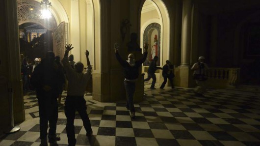 Anti-government demonstrators enter the Rio de Janeiro's Municipal Chamber as they try to occupy it