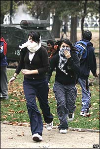Students run as police fire teargas in Santiago